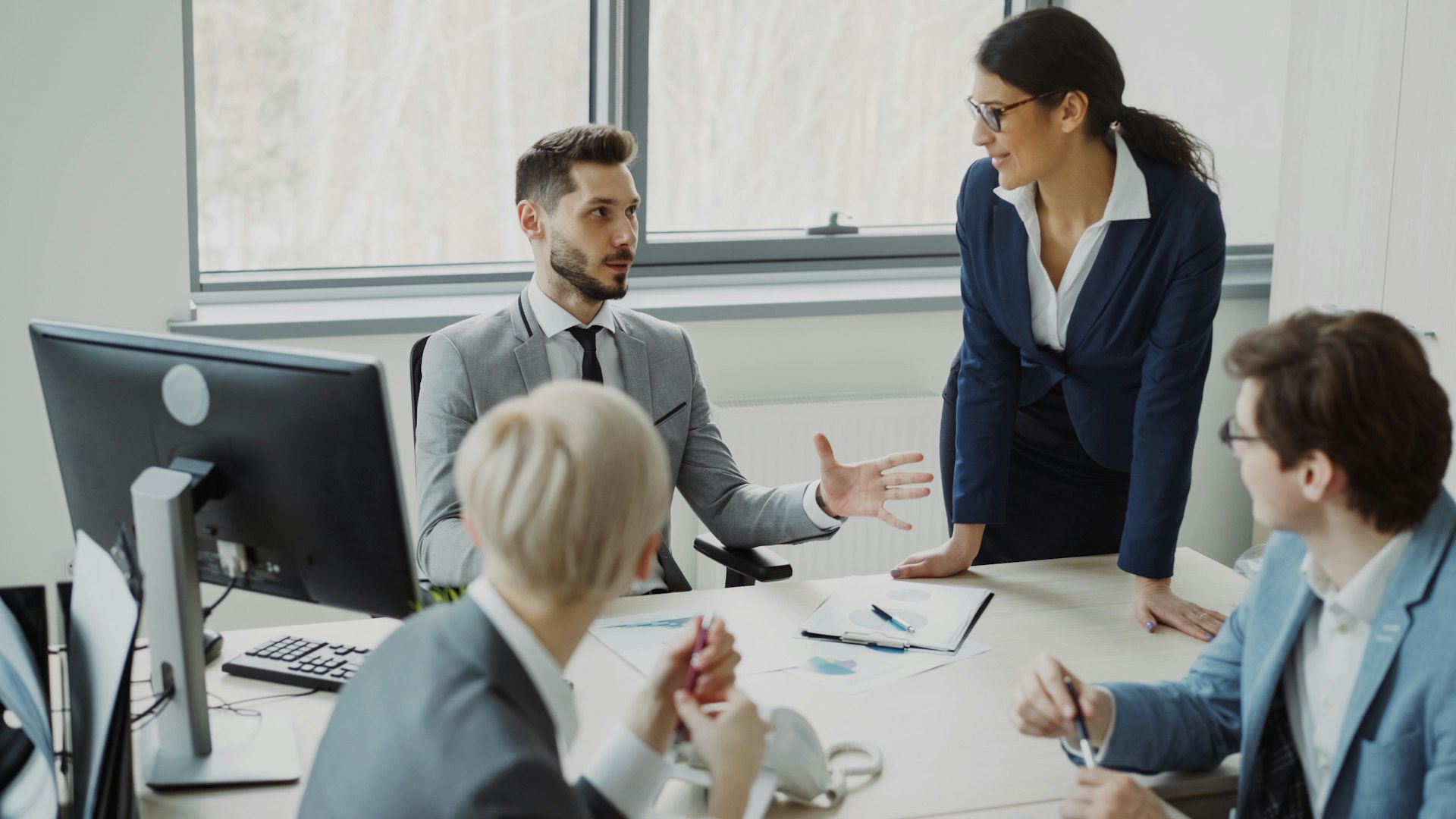 Small professional team collaborating in a modern office meeting