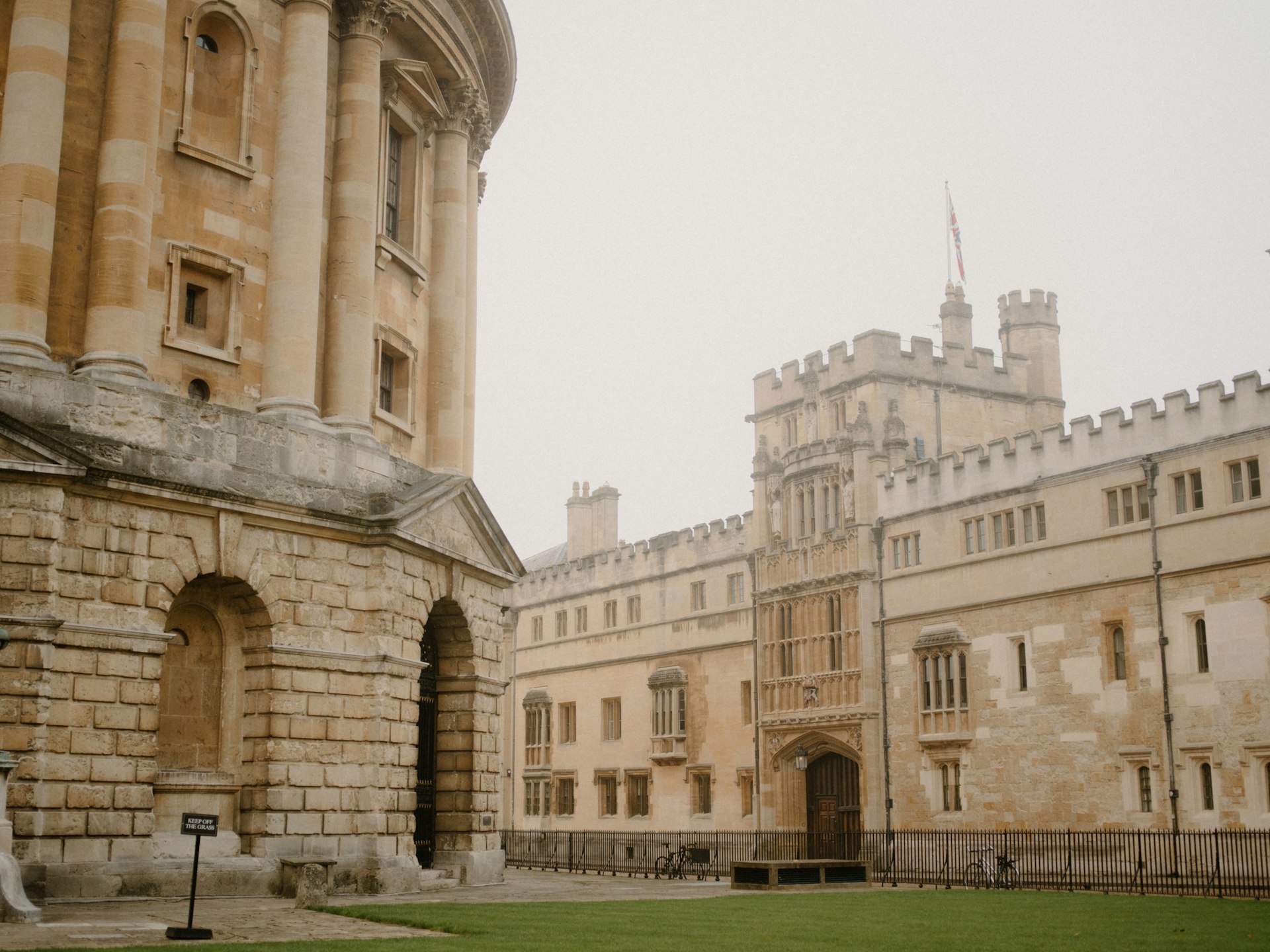 Historic university buildings around a grassy courtyard